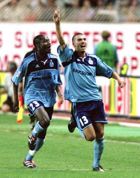 Marseilles Jerome Leroy (R) celebrates his goal with