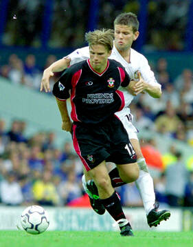 Anders Svensson of Southampton in front of Ian Harte of