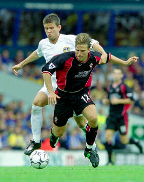 Anders Svensson of Southampton in front of Ian Harte of