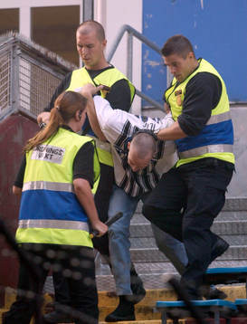 En Partizan supporter som kastat en rökbomb omhändertas
