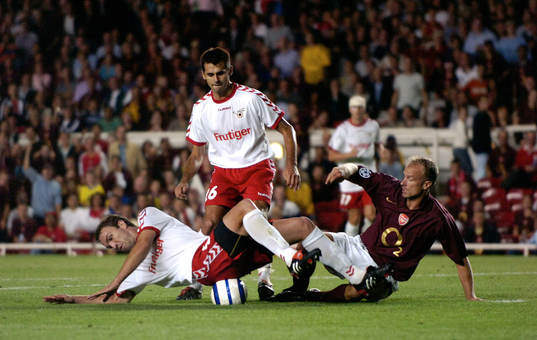 Dennis Bergkamp tacklar en Thun-spelare