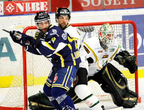 Johan Lindström, HV71, hålls fast av Färjestads försvar