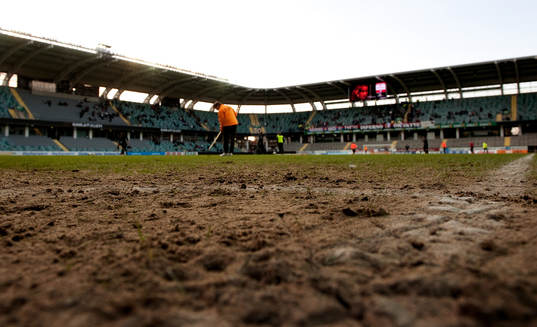 Gamla Ullevi, gräsmatta. Funktionär krattar. Dålig plan