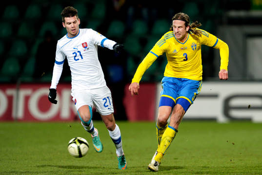 Jonas Olsson, Sverige, jagar bollen från Michal