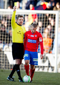 Markus Strömbergsson, domare, ger gult kort till