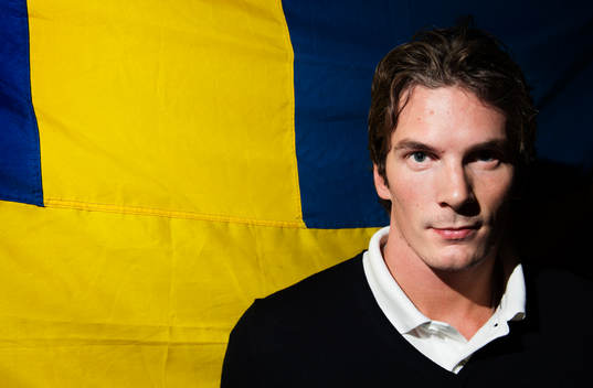 Loui Eriksson poserar framför en svensk flagga när det