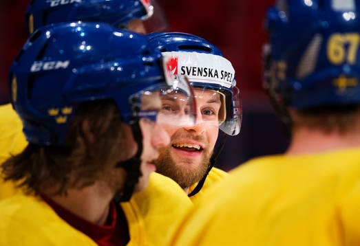 Fredrik Pettersson tittar fram mellan två spelare på