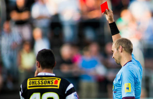 Domaren Jim Petersson från Motala höjer det röda kortet