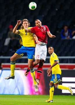 Sveriges Jonas Olsson i en luftduell med Norges Daniel