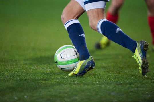 Fotboll, gräsmatta, fotbollsskor i