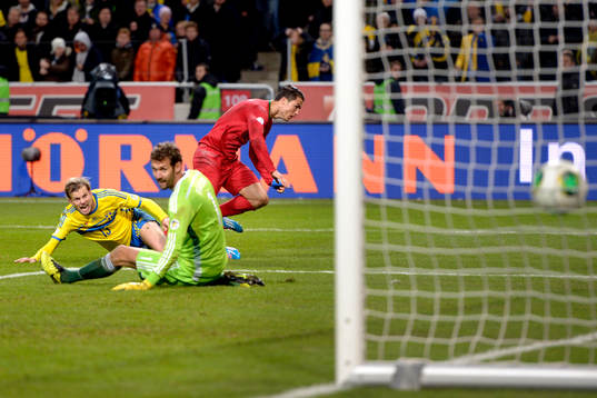 Sveriges Mikael Antonsson och målvakt Andreas Isaksson ser