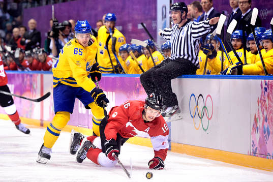Sveriges Erik Karlsson i kamp om pucken med Kanadas