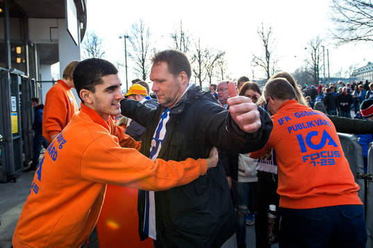Säkerhetspersonal visiterar publiken innan fotbollsmatchen