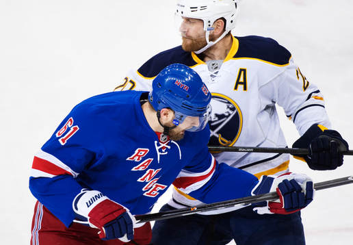 Buffalos Henrik Tallinder (t h) tacklar New Yorks Rick Nash