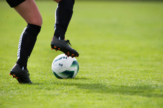 Fot, fotbollssko, boll, gräs i matchen i damallsvenskan i