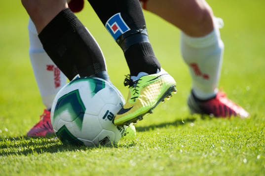 Fot, fötter, fotboll, gräs, fotbollsskor i matchen i