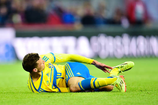 Sveriges Marcus Berg blir liggande och tar sig om foten