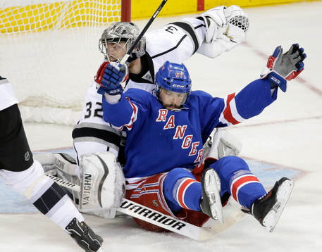 New York Rangers left wing Benoit Pouliot (67) crashes into