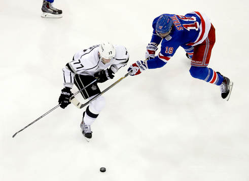Los Angeles Kings center Jeff Carter (77) is impeded by New