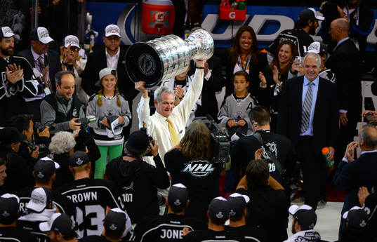 Darryll Sutter coach of the Los Angeles Kings lifts the