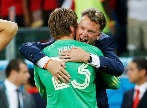 Tim Krul of the Netherlands is hugged by coach Louis van