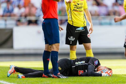 Mjällbys målvakt Mattias Asper ligger skadad på gräset