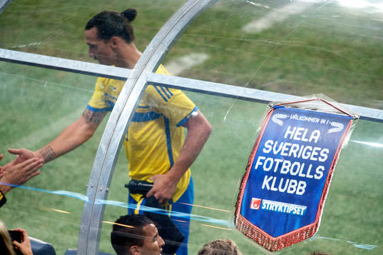 Sveriges Zlatan Ibrahimovic bakom reklamskylt för