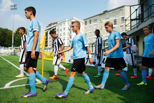 s spelare gör entré till fotbollsmatchen i UEFA Youth