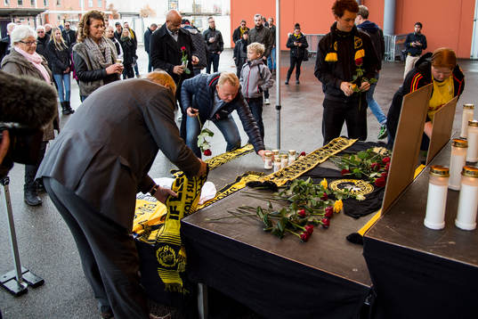 Sörjande supportrar lägger ner blommor och halsdukar
