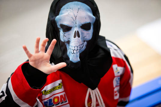 En ung supporter med Örebrotröja och Halloweenmask