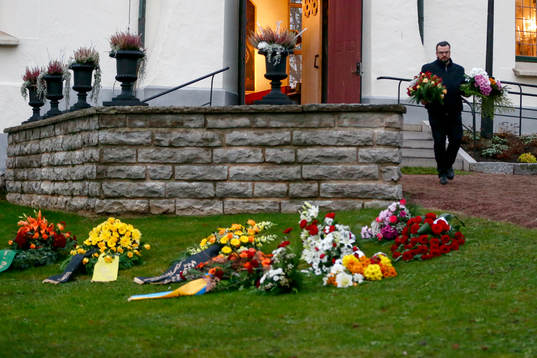 Blom buketter läggs utanför kyrkan