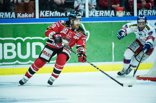 Malmö Redhawks Jens Olsson med pucken framför Oskarshamns