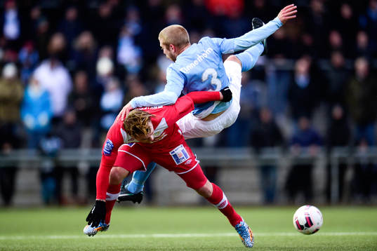 Malmö FFs Anton Tinnerholm tacklas omkull av Assyriskas