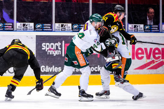 Färjestads Milan Gulas tacklar Brynäs Greg Scott