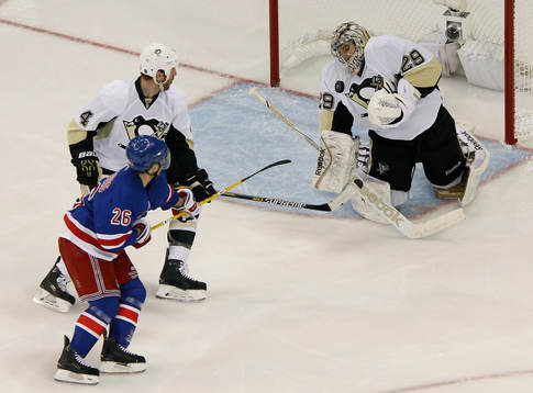 Pittsburgh Penguins goalie Marc-Andre Fleury (R) makes a