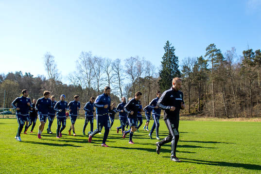 Laget värmer upp innan en fotbollsträning med IFK