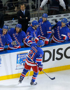 New York Rangers Derek Stepan slaps hands with teammate