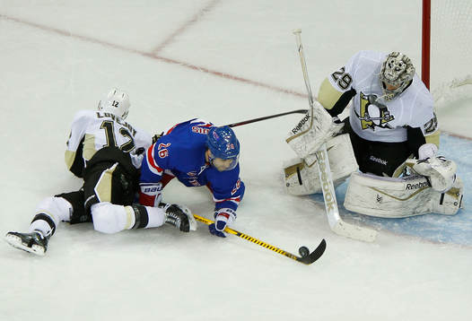 Pittsburgh Penguins goalie Marc-Andre Fleury (R) makes a