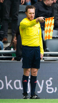 En linjedomare signalerar för offside