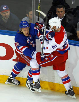 New York Rangers Carl Hagelin (L) checks Washington
