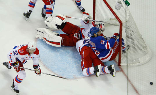 New York Rangers Derick Brassard (R) is knocked into the