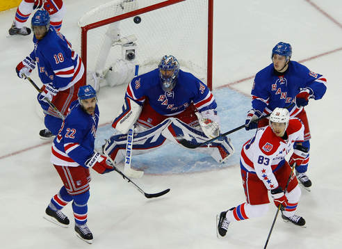 The puck bounces away from New York Rangers Marc Staal