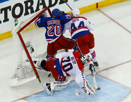 New York Rangers Chris Kreider is knocked into the net by