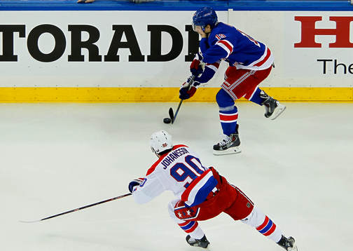 New York Rangers Jesper Fast (R) skates past Washington