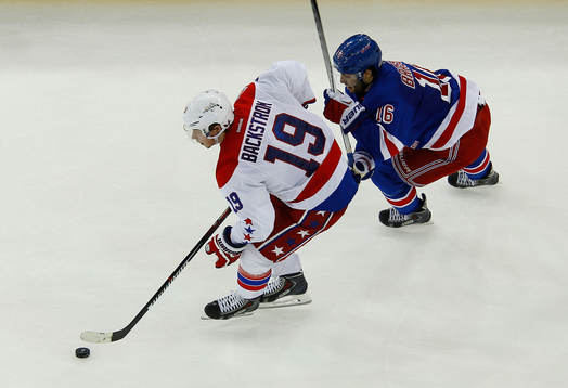 Washington Capitals Nicklas Bäckstrom (L) skates away from