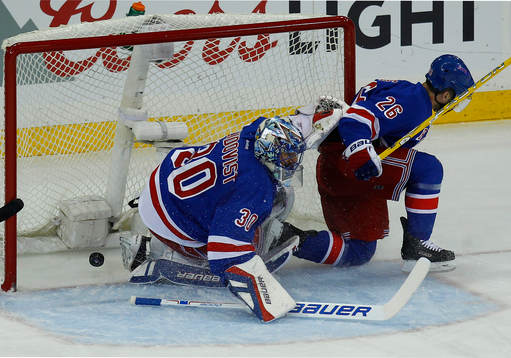New York Rangers goalie Henrik Lundqvist (L) lets in a goal
