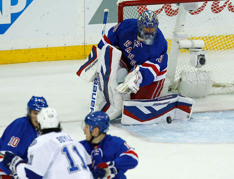 New York Rangers goalie Henrik Lundqvist (R) makes a save
