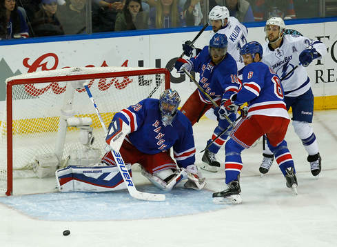 New York Rangers goalie Henrik Lundqvist (L) makes a save