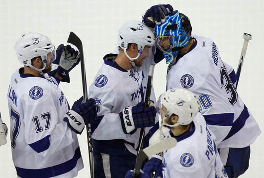 Tampa Bay Lightning goalie Ben Bishop (R) bumbs heads with