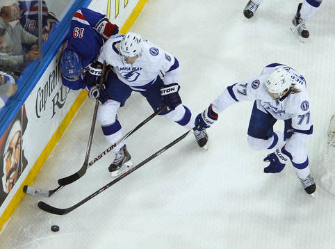New York Rangers Jesper Fast (L) is checked into the boards